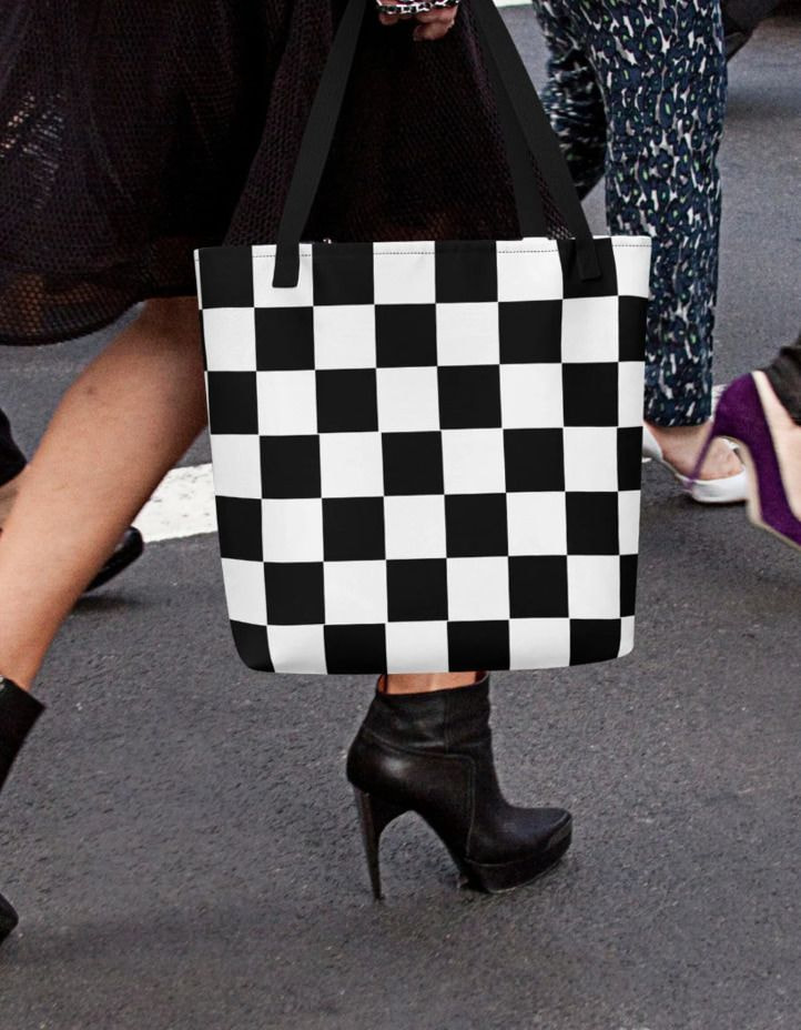 a woman carrying a checkered bag